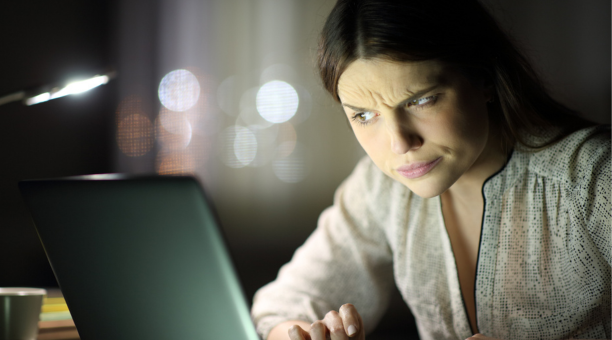 Woman look confused at screen 