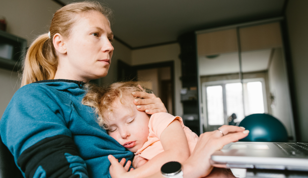 Mother cares for child while working