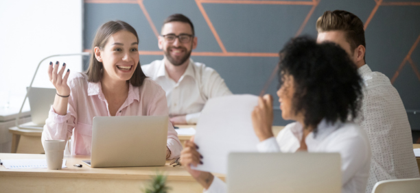 Coworkers talk at table