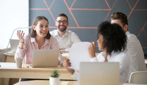 Coworkers talk at table