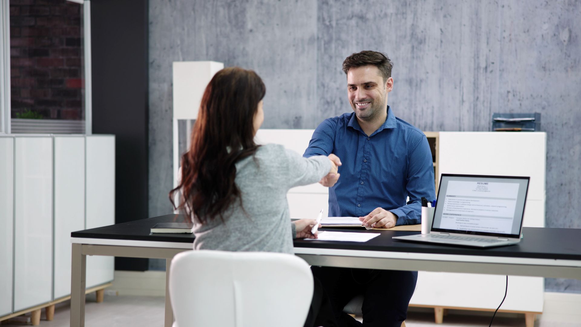 Candidate shaking hands with recruiter
