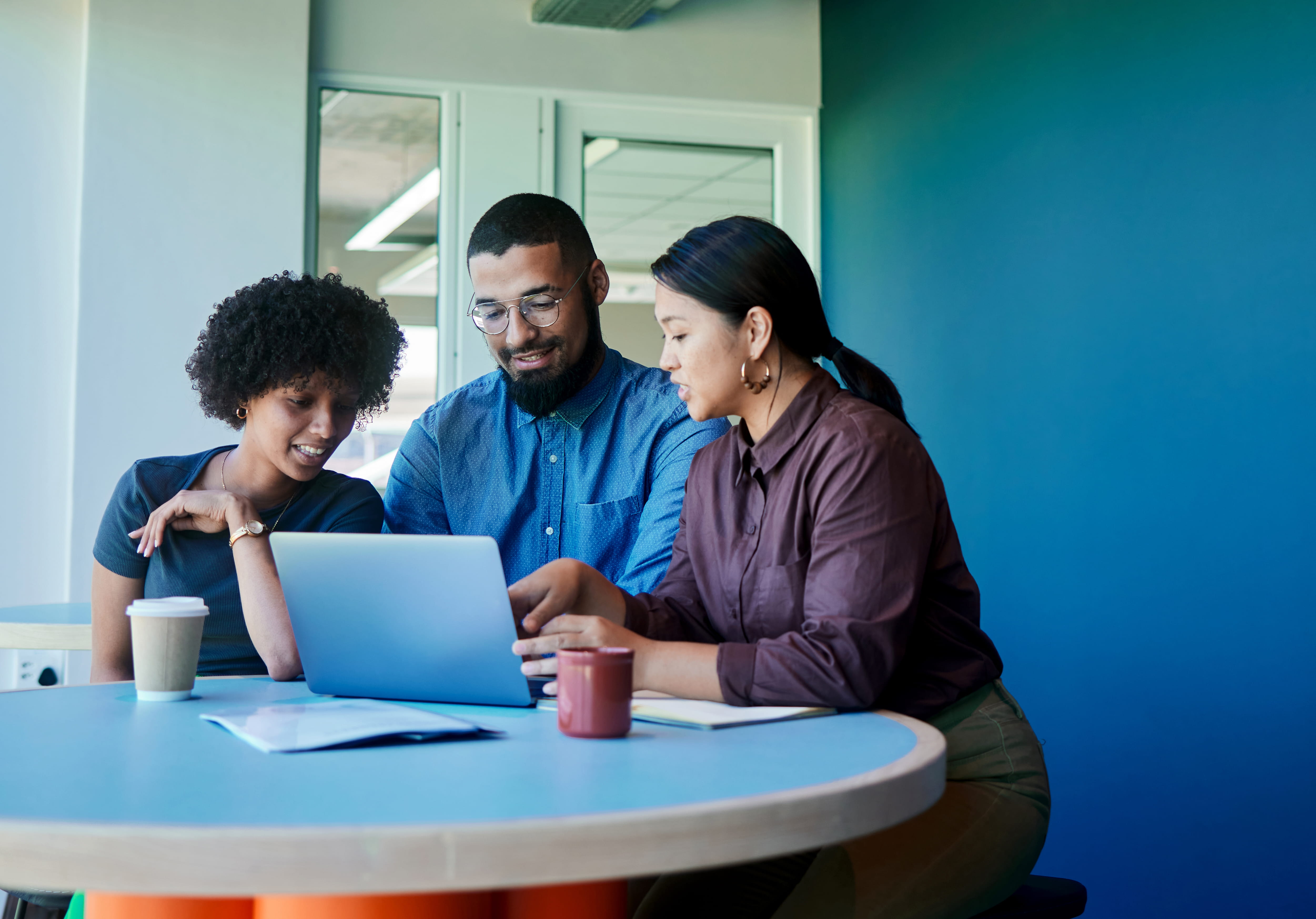 People talking at a table at work.
