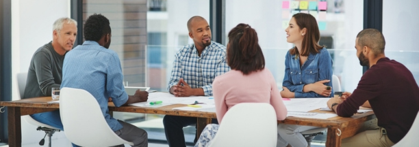 Group of employees at conference table. 