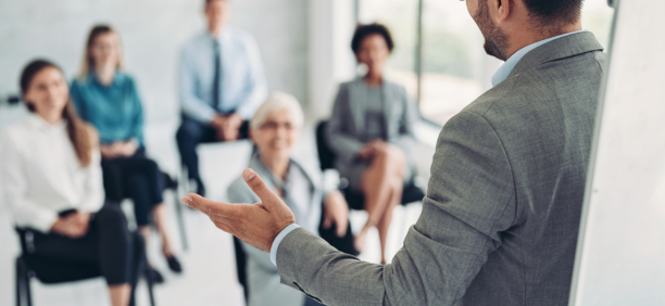 Employer giving a presentation to employees. 