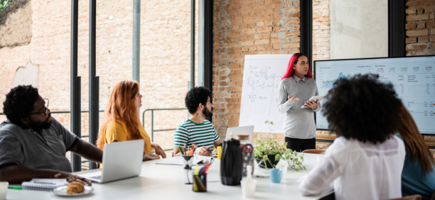 Group of diverse employees working together in a conference room.