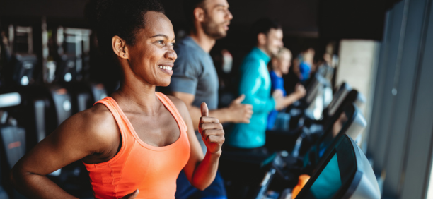 woman jogging on treadmill in gym
