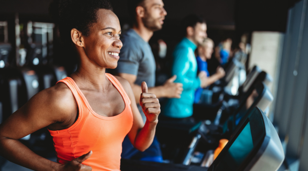 woman jogging on treadmill in gym